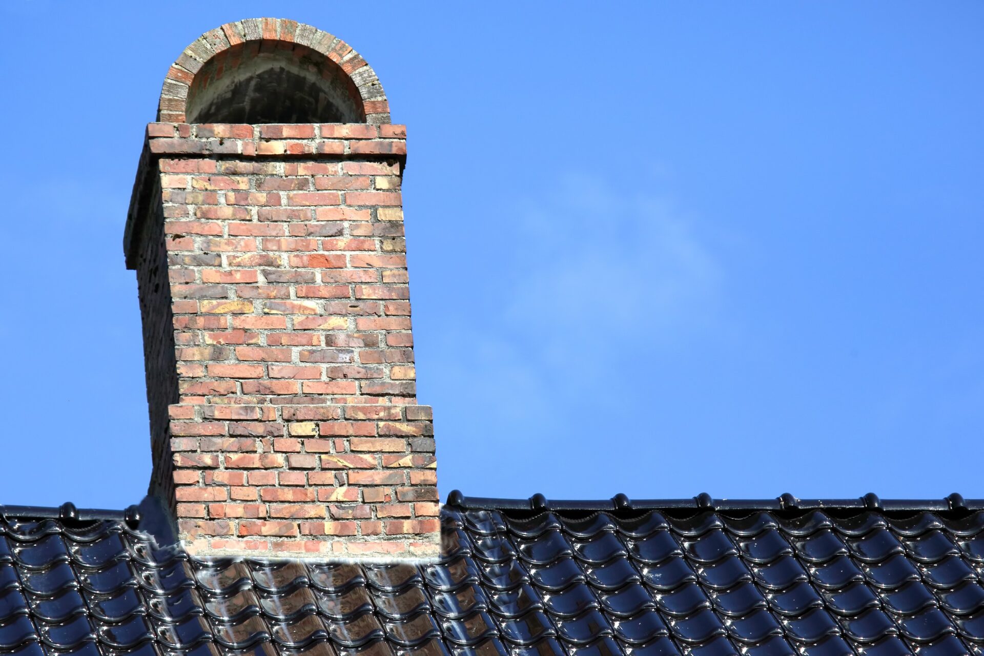 brick chimney on the roof with tiles<br />
